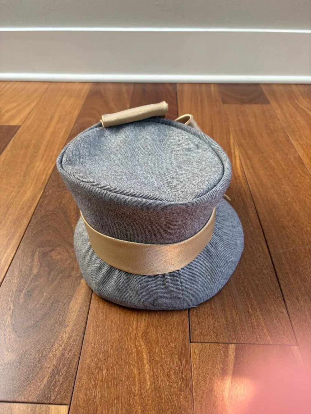 Ms. Divine vintage wool cloche hat with gold flecks while featuring a prominent
